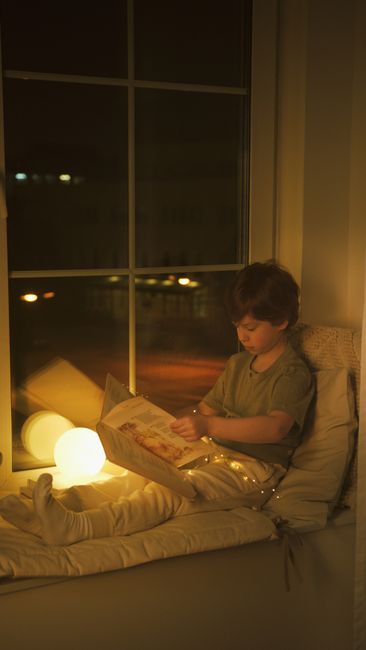 Child reading window light